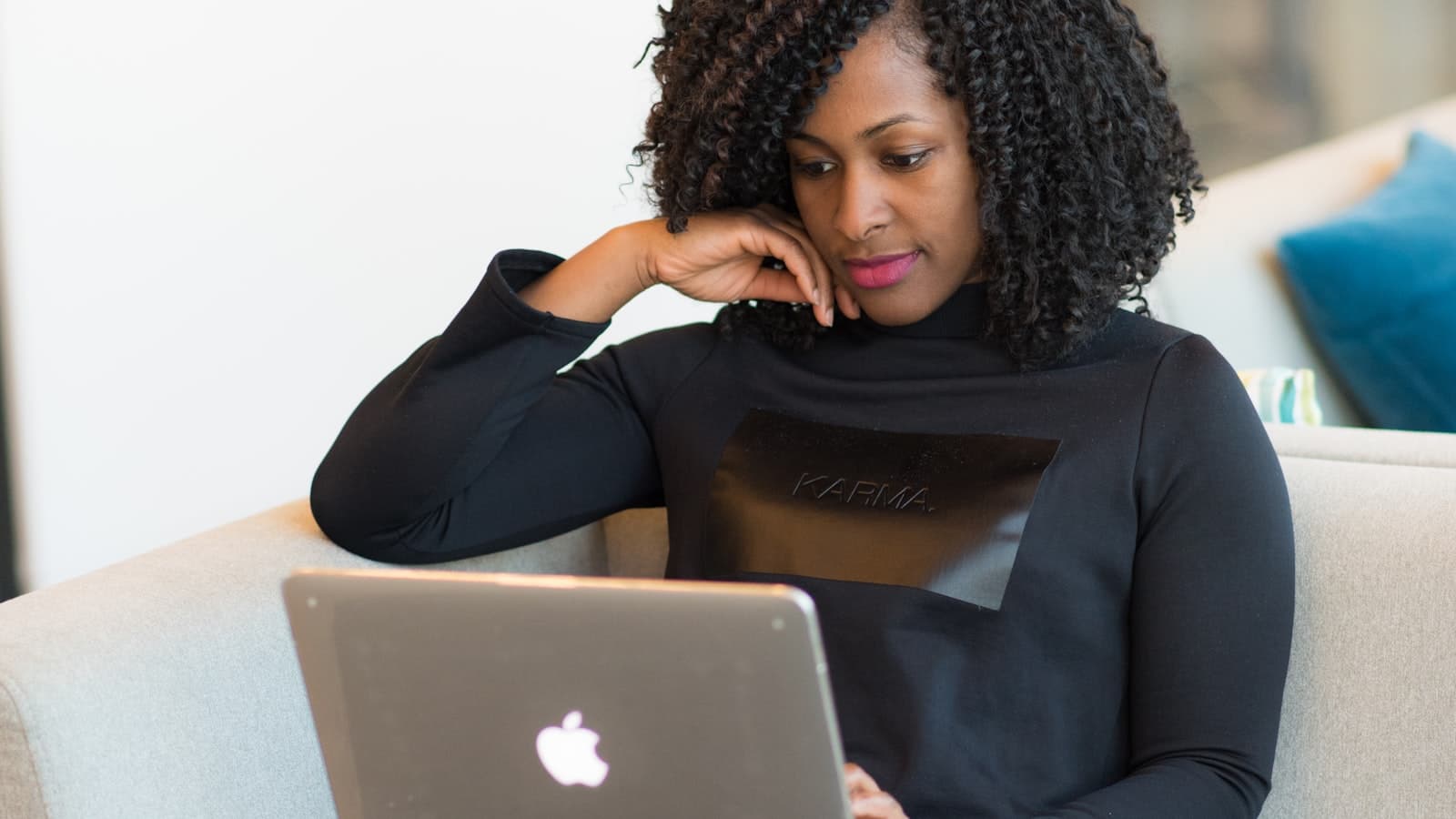 A woman comparing online earning platforms on a laptop